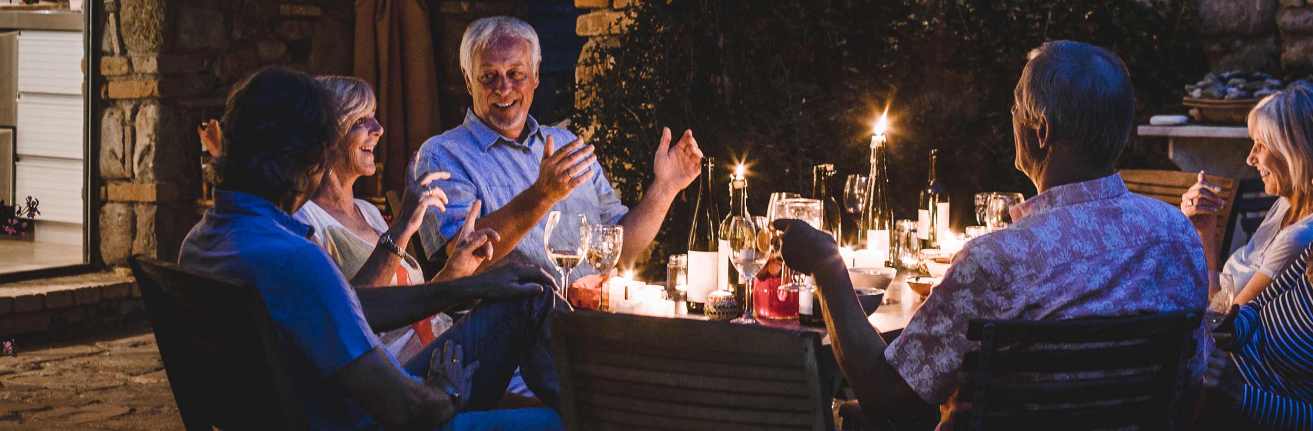 People gathered around outdoor dining table