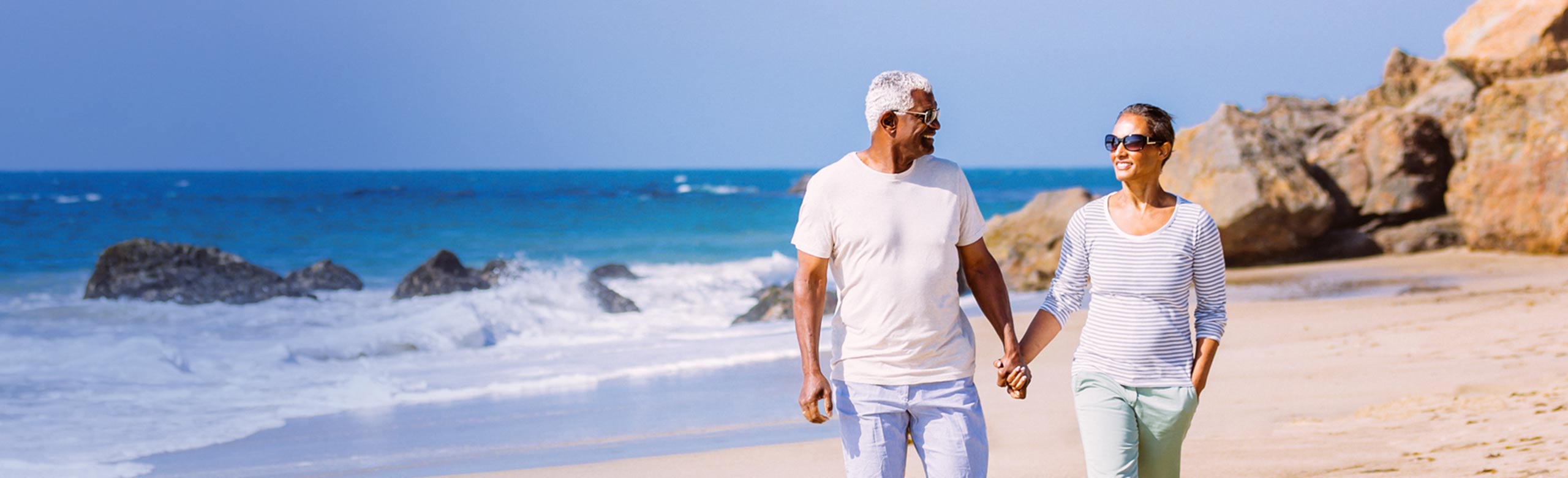 Couple holding hands on  beach