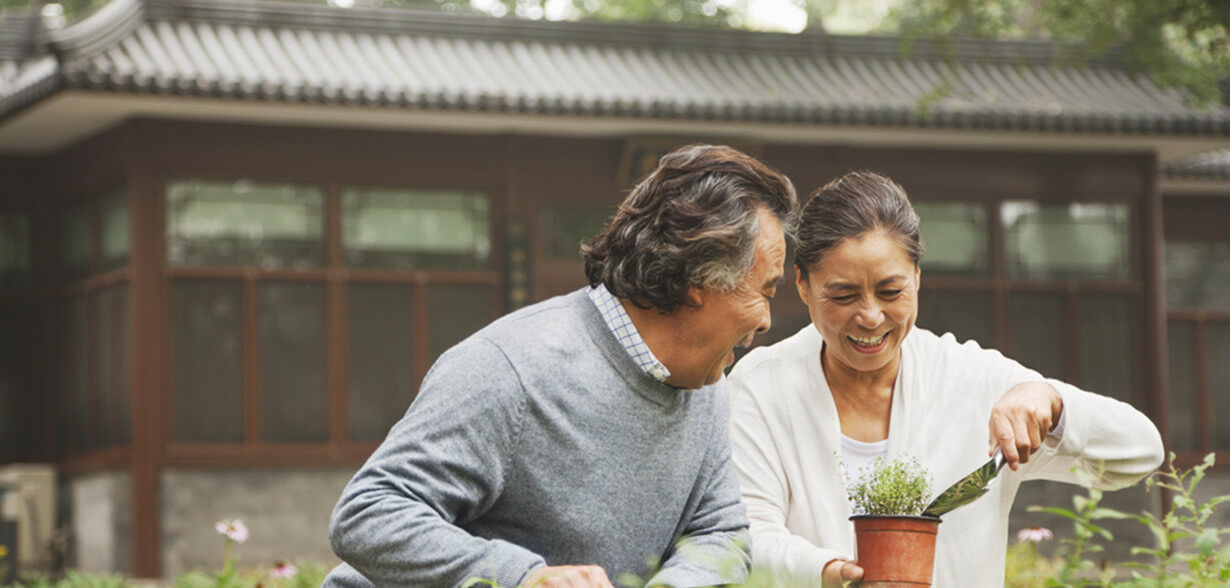 Couple gardening together outside